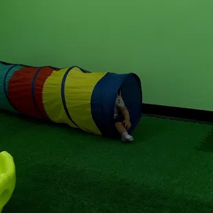 1year old in green room in tunnel