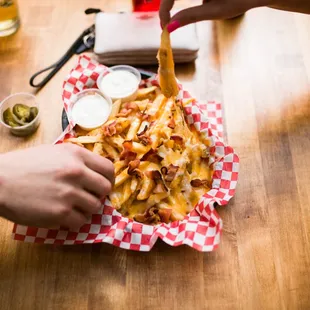 a plate of french fries and a glass of beer