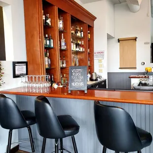 a bar with black chairs