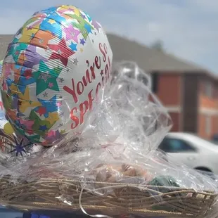 a woman carrying a basket with a balloon on it