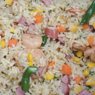 a pan of rice with ham and vegetables