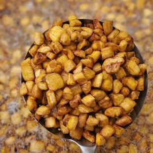 a spoon full of fried potatoes