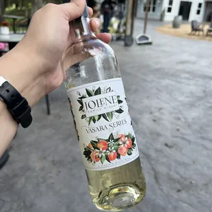 a person holding a bottle of wine