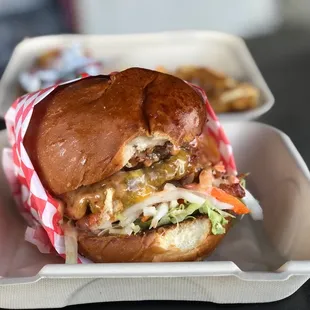 a burger in a styrofoam container