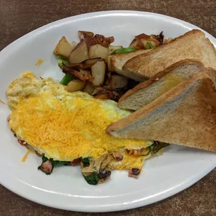 Ultimate Omelette with homestyle potatoes and white toast. It was loaded with veggies and all the meat options. Definitely filling!