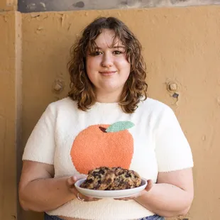 a woman holding a plate of cookies