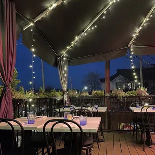 tables and chairs under a canopy