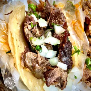 a taco with meat and onions