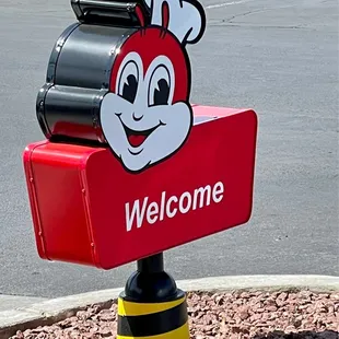 a red mailbox with a cartoon character on it