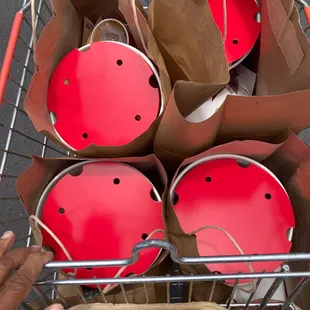 a cart full of red buckets