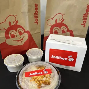 a bag of jollibee and a plate of food