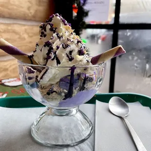 an ice cream sundae with purple sprinkles