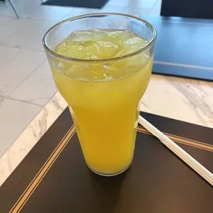 a glass of juice on a table