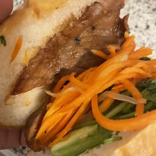 a hand holding a sandwich
