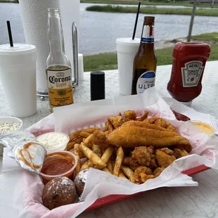 a basket of fried fish and fries