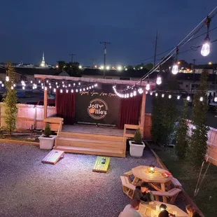 Outdoor seating at Jolly Ollie&apos;s Pizza and Pub in Hendersonville, TN. Beautifully designed with lighting and an outdoor bar for convenience.