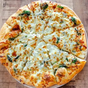 a pizza with cheese and spinach