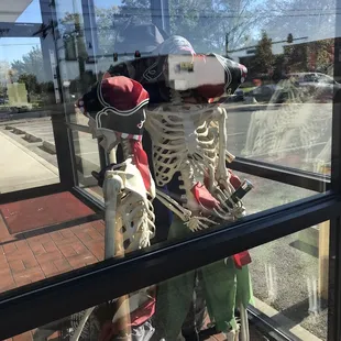 a skeleton in a store window