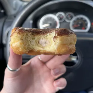 a hand holding a donut