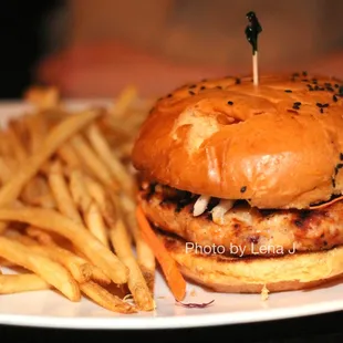 Salmon Burger ($17) - salmon patty, slaw, tomato slice, sambal mayo, sriracha-sesame brioche