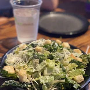 a plate of salad and a glass of water
