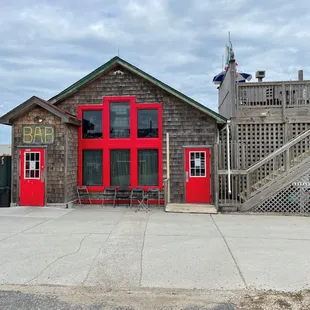 the front of a building with a red door