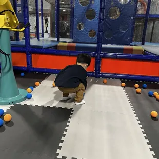 My son picking up some balls