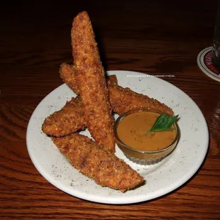 Fried pickles.  Spicy dill pickle lightly breaded + fried crisp, served with the house-made dark ale mustard.