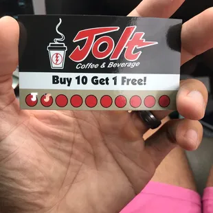 a hand holding a coffee and beverage gift card