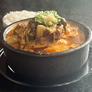 Haejang-Guk (Pork Bone Soup) with a bowl of Rice peeking from behind.