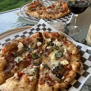 two pizzas and a glass of wine