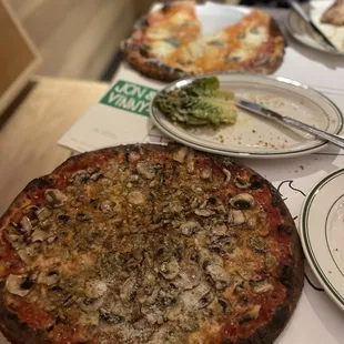  pizza with mushrooms on it