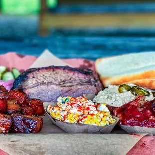 Bacon Burnt Ends / Brisket / Corn Salad / Grits / Strawberry Crisp / Pickles / Bread