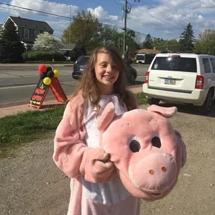 The girl behind the pig