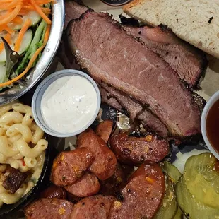 BBQ plate with side salad and Mac, sliced brisket, and jalapeños cheese sausage.