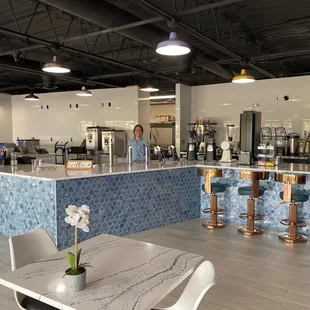 a restaurant with a large counter and chairs