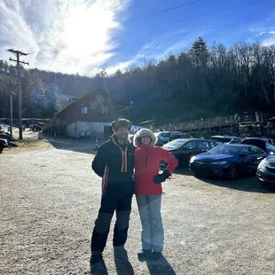 My husband and I with the lodge and hill in the background.