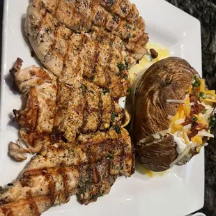 Grilled chicken tenders and loaded potato.