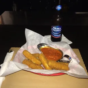 Afternoon snack. Cheese sticks and a beer.