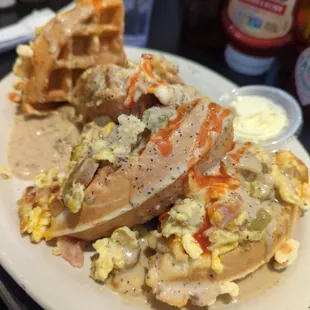 Stuffed waffles- I know looks like a train wreck but the sausage,bacon baked in with jalapeno pepper gravy and scrambled eggs,hot sauce yum
