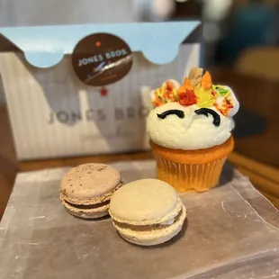 a cupcake and two macarons