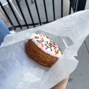 Vanilla iced cronut with sprinkles