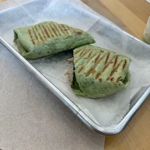 Spinach wrap with turkey, pesto cream cheese, onions, spinach and feta