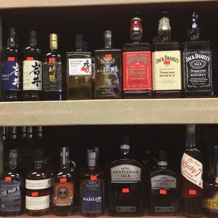 a shelf full of liquor bottles