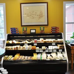 a display of cheeses, jams, and jellys