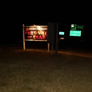 a sign for a business at night