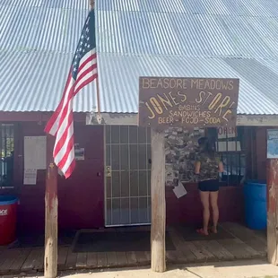 a woman standing in front of the store