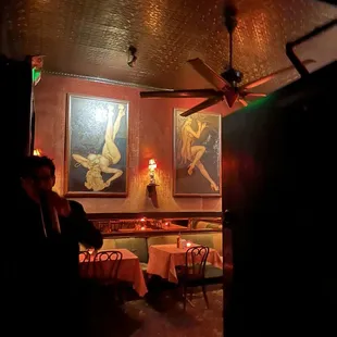 a man sitting at a table in a dimly lit restaurant