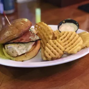 a sandwich and waffle fries