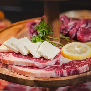 a variety of meats on a wooden platter